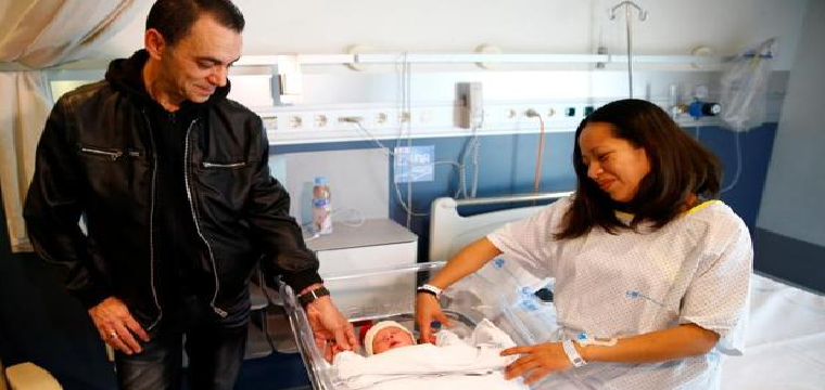 Karem y Joaquín miran a su hijo Derek, el primer madrileño nacido en 2018 - EFE